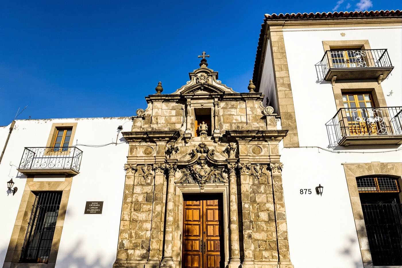 The whitewashed colonial facade of a historic library building
